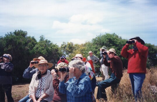 Photograph of people with binoculars