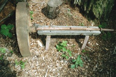 wheel and axle resting on wood