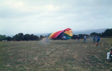 Photograph of people and a large kite