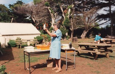 Photograph of woman standing in front of an activity table