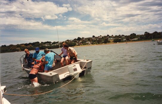 Photograph of people on a small boat