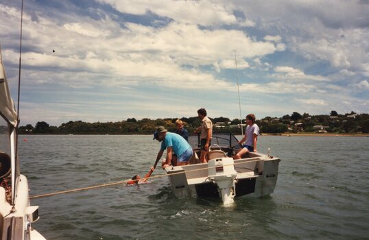 Photograph of people on a small boat