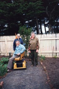 Photograph of three people in herb garden
