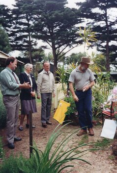 Photograph of group standing in garden