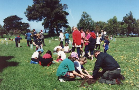 Photograph of people gathered in a field
