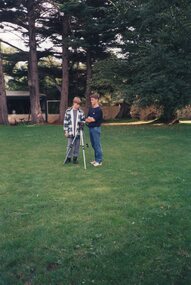 Photograph of children with a camera and tripod