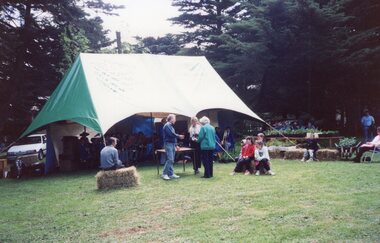 Colour photograph of people gathered around a marquee