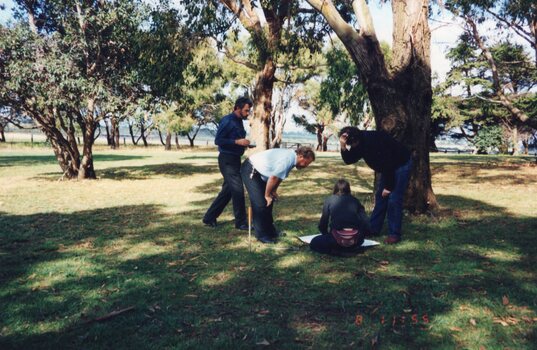 A photograph of four people