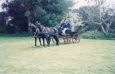 Photograph of people on wagon