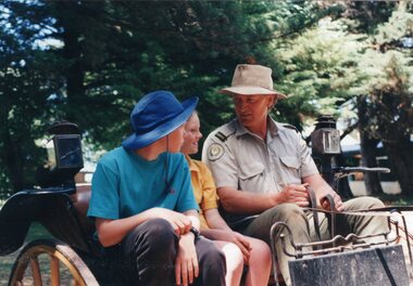 Photograph of two schoolchildren and employee