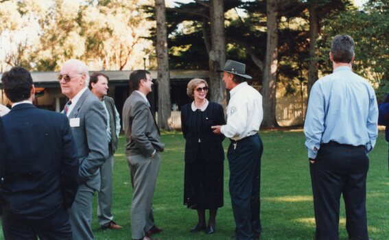 Photograph of group of people talking