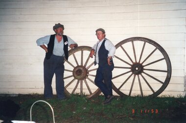 photograph of two men and wheels