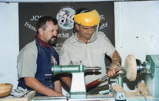 photograph of two men wood turning