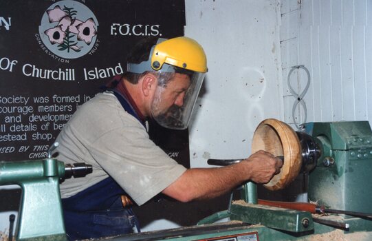 a Photograph of man woodturning