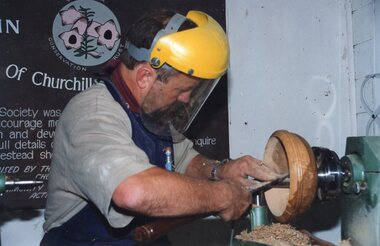 a Photograph of man woodturning