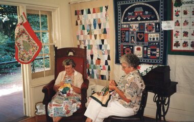 Photograph of two woman quilting