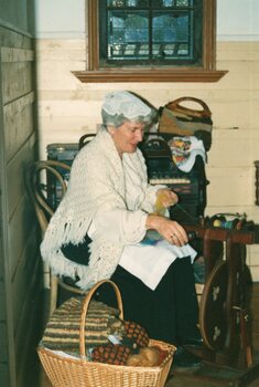 Photograph of woman spinning wool