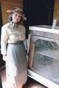 Photograph of woman beside Coolgardie Safe