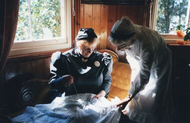 Photograph of two women embroidering