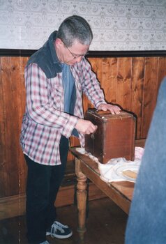 Photograph of man churning butter