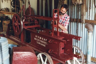 Colour photograph of man working on machinery