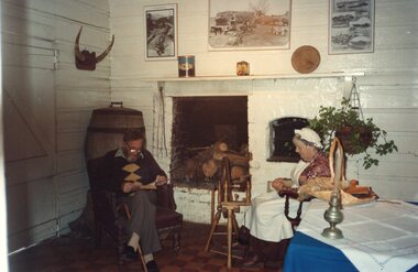 Colour photograph of couple sitting in chair