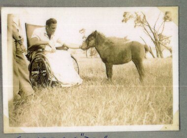 Photograph of man and pony