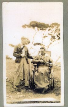 photograph of three people and a gun