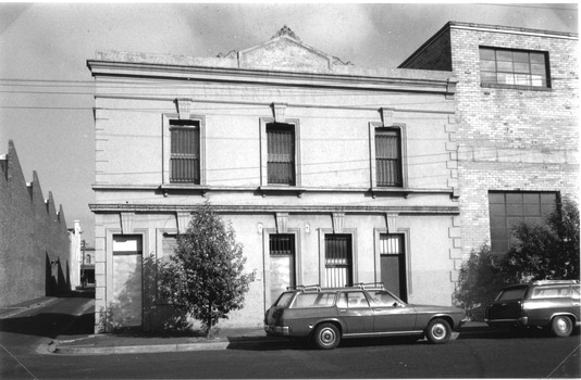 Two storey building with a lane running down the side.