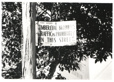 Sign attached to a lamppost reading "Timber, Coal, Briquette Traffic is Prohibited in this Street".