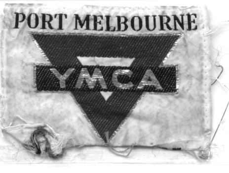 Cloth badge with 'Port Melbourne' embroidered along the top and 'YMCA' in a bar across an inverted triangle.