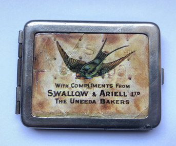 Metal matchbox with paper insert featuring a swallow and the text 'with compliments from Swallow & Ariell Ltd, the Uneeda Bakers' on a background of a Uneeda biscuit.