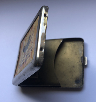 Small metal matchbox open to show the interior.