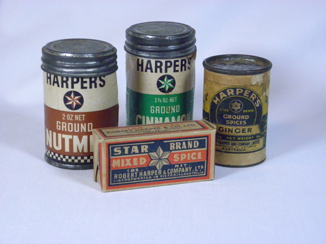 From left to right small canisters of ground nutmeg, ground cinnamon and ground ginger with a box of mixed spice at the front.
