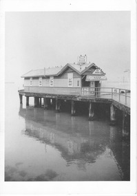 Black & white photo of a kiosk at the end of a pier.