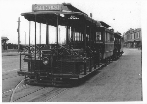 A "Spring Street" cable tram in an otherwise empty street.