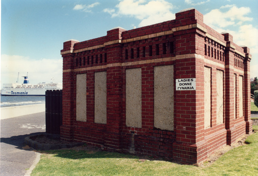 Ladies public conveniences on Port Melbourne foreshore constructed in red brick with signage in English, Italian and Greek.  