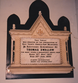 Large white ornate tablet with black writing dedicated in remembrance to Thomas Swallow.