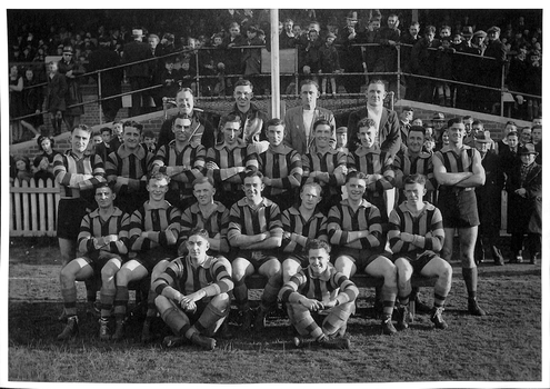 Four rows of men in Port Melbourne football gear in typical football team pose.