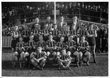 Four rows of men in Port Melbourne football gear in typical football team pose.