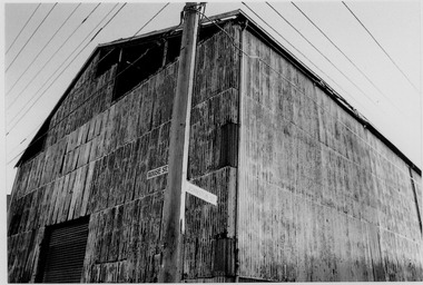 Very large shed constructed of corrugated iron.