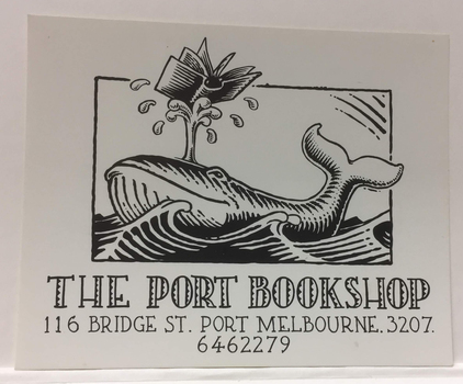 Business card for The Port Bookshop with address and phone number and an illustration of a whale balancing an open book on its water spout.