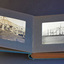 Photograph album open to display two black and white photographs, one on each page.