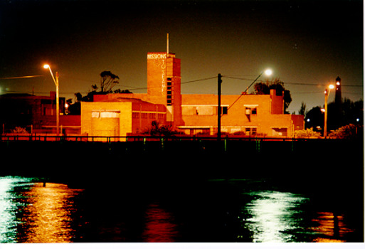 coloured photo of a building close to the water edge.