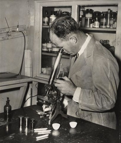 A man looking into a microscope.