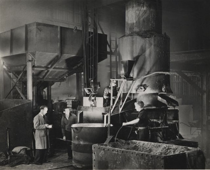 Black & white photo of three men working at their job.