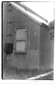 Black & white photo of corrugated iron building.