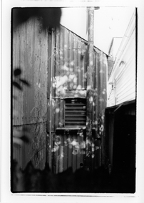 2Black & white image of part of a corrugated iron building.