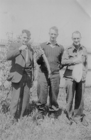 Photograph - Charlie Landorf and two friends holding a fish, Fishermen's Bend, 1940s