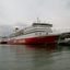 Two ships berthed at a large pier.